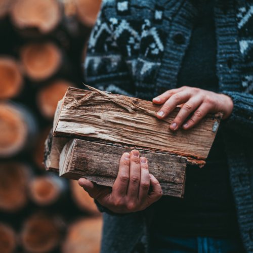 Man,Hands,Holding,Firewood.,Unrecognizable,Male,Caring,Wood,Logs,To